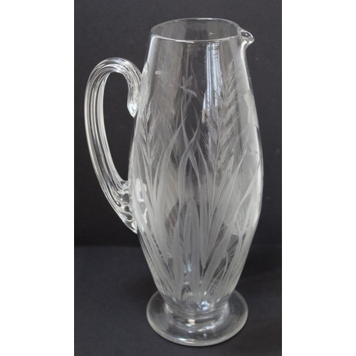 243 - Late 19th/early 20th century water jug of ovoid form with reeded handle and etched decoration of but... 