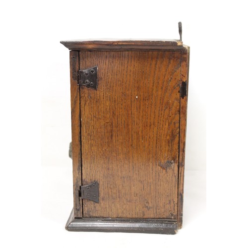 208 - Small Georgian oak hanging cupboard of rectangular form, the panelled door opening to reveal three s... 