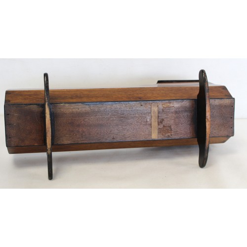 213 - 19th century mahogany doll's cradle with shaped hood on two solid rockers, 50cm long.