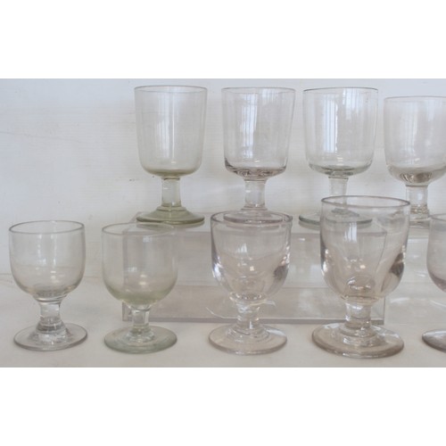 215 - Collection of fourteen antique drinking glasses with rounded bucket bowls on plain stems and circula... 