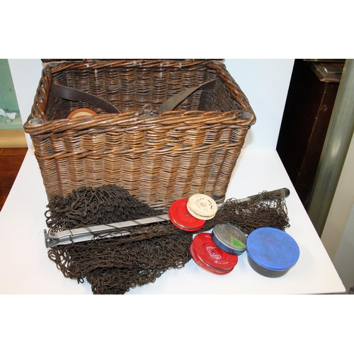 112 - Wicker box containing fishing tackle including lures, line, etc. and a landing net
