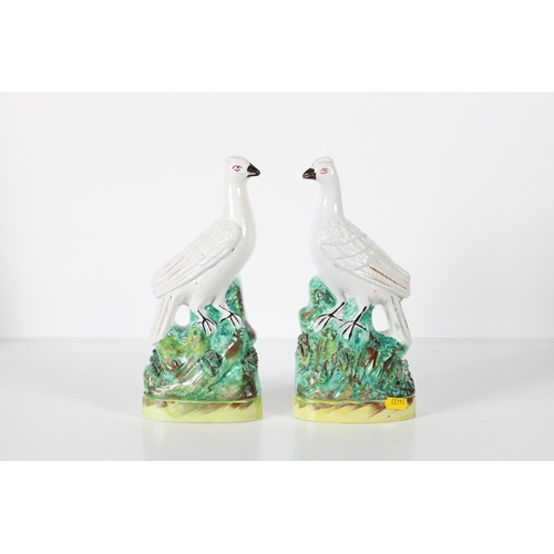 13 - Pair of Staffordshire pottery bird models, 25cm tall.