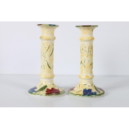 40c - Pair of Poole Ferrucio column candlesticks, hand-painted with floral decoration on spattered yellow ... 