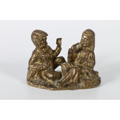 50 - Cast metal model of a girl and boy at picnic, 12cm long.