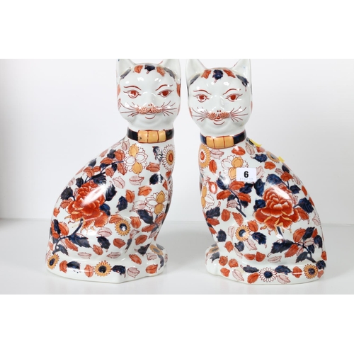 6 - Pair of large Oriental cats decorated with Imari palate floral sprays, four character mark to the ba... 
