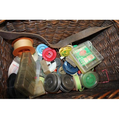 112 - Wicker box containing fishing tackle including lures, line, etc. and a landing net