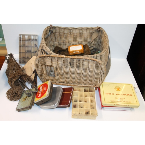 135 - Wicker fishing basket containing fishing tackle, tins, etc. and a canvas satchel containing fishing ... 