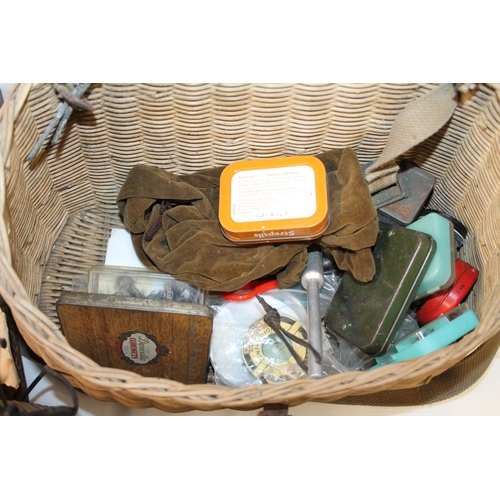 135 - Wicker fishing basket containing fishing tackle, tins, etc. and a canvas satchel containing fishing ... 