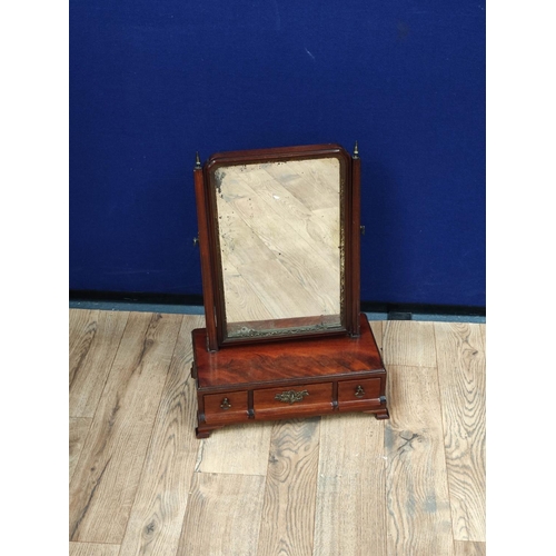 615 - Georgian mahogany dressing glass, the swing mirror above a central drawer flanked with a small drawe... 