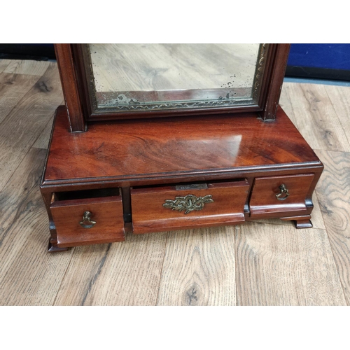 615 - Georgian mahogany dressing glass, the swing mirror above a central drawer flanked with a small drawe... 