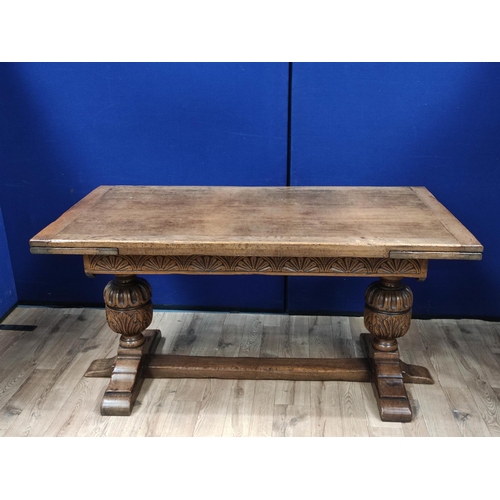 616 - Oak refectory draw leaf dining table, the draw leaf plank top above a carved frieze, raised on carve... 