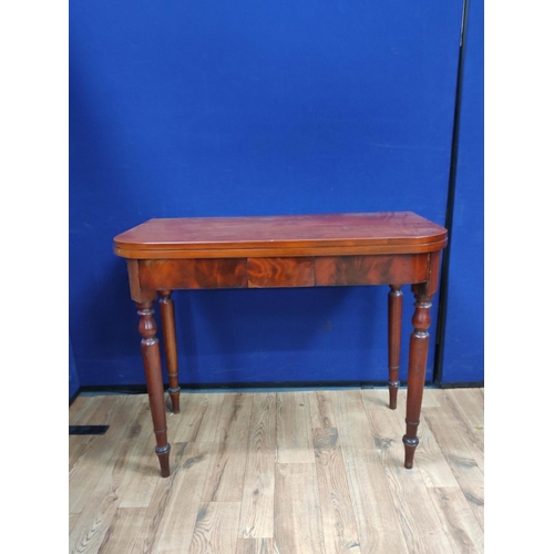 621 - Mahogany folding card table, the swivel top raised on turned legs. 76cm high, 94cm wide and 100cm lo... 