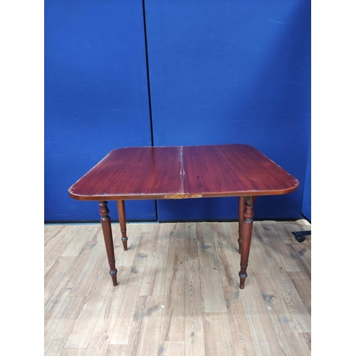 621 - Mahogany folding card table, the swivel top raised on turned legs. 76cm high, 94cm wide and 100cm lo... 