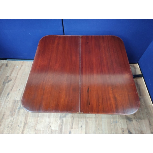 621 - Mahogany folding card table, the swivel top raised on turned legs. 76cm high, 94cm wide and 100cm lo... 