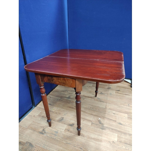 621 - Mahogany folding card table, the swivel top raised on turned legs. 76cm high, 94cm wide and 100cm lo... 