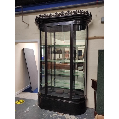 623 - Antique ebonised shop cabinet, with gothic style trellis pediment above a glazed door enclosing glas... 