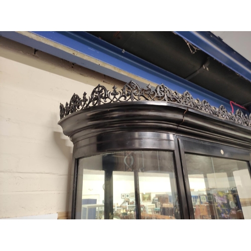 623 - Antique ebonised shop cabinet, with gothic style trellis pediment above a glazed door enclosing glas... 