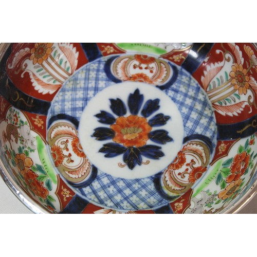 252 - Graduated pair of Japanese Imari bowls with panels of flowers and mythical creatures and silver rims... 