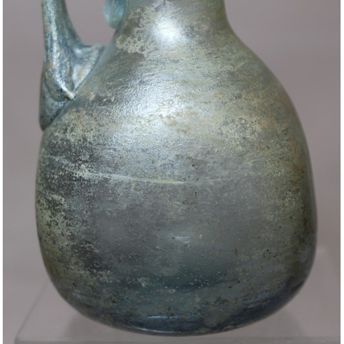 261 - Antique glass flask or ewer, possibly Roman, the flattened globular base with tall flared neck, fold... 