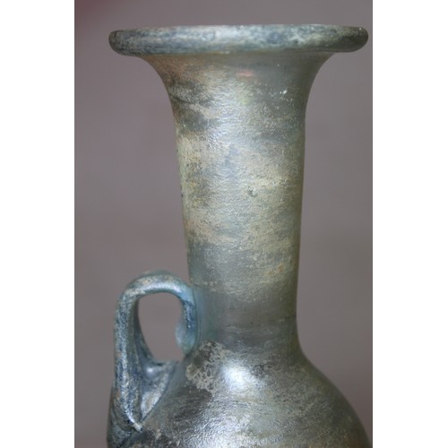 261 - Antique glass flask or ewer, possibly Roman, the flattened globular base with tall flared neck, fold... 