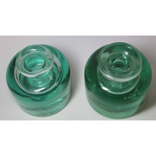 262 - Two 19th century heavy green glass inkwells of cylindrical form with sloping shoulders, short neck a... 