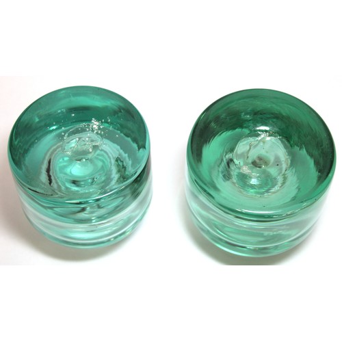 262 - Two 19th century heavy green glass inkwells of cylindrical form with sloping shoulders, short neck a... 