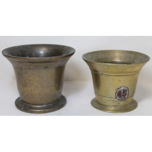 264 - Antique bronze mortar of flared circular form, 15cm diam. and another smaller, 13.5cm diam.  (2).