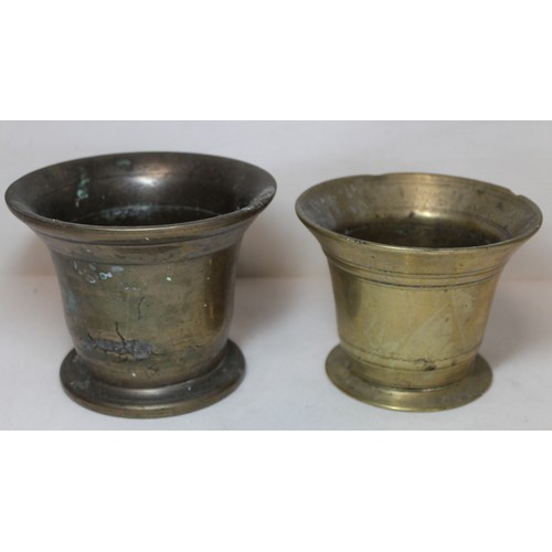 264 - Antique bronze mortar of flared circular form, 15cm diam. and another smaller, 13.5cm diam.  (2).