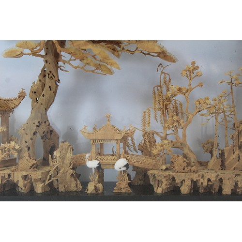 266 - Chinese carved cork diorama depicting a pavilion on a lake with trees and cranes, contained in eboni... 