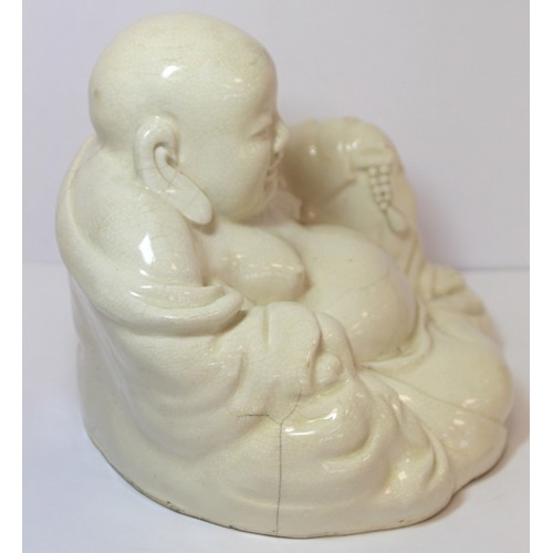 267 - Oriental white glazed pottery figure of Buddha or Hotei, seated and smiling, 17cm high.