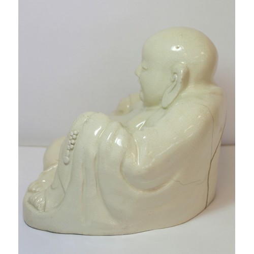 267 - Oriental white glazed pottery figure of Buddha or Hotei, seated and smiling, 17cm high.