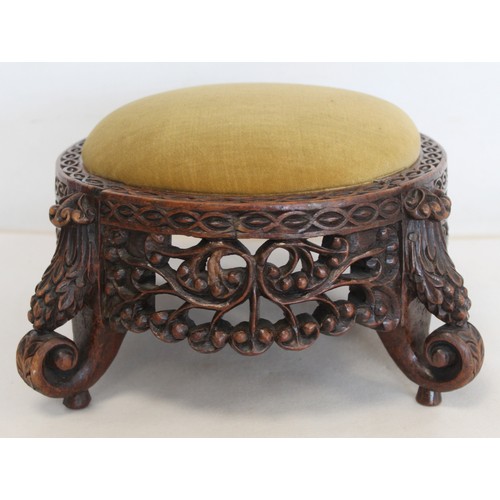 271 - Eastern pierced and carved hardwood footstool of oval form with four scroll feet and foliate decorat... 