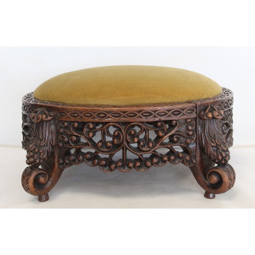 271 - Eastern pierced and carved hardwood footstool of oval form with four scroll feet and foliate decorat... 