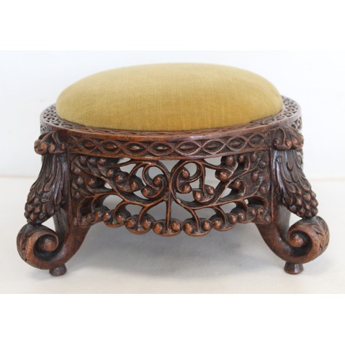 271 - Eastern pierced and carved hardwood footstool of oval form with four scroll feet and foliate decorat... 