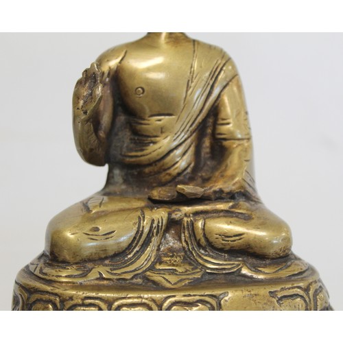 274 - Eastern bronze figure of a Buddha seated on a lotus throne, hollow base, 15cm high.