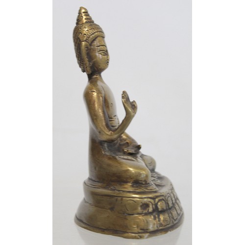 274 - Eastern bronze figure of a Buddha seated on a lotus throne, hollow base, 15cm high.