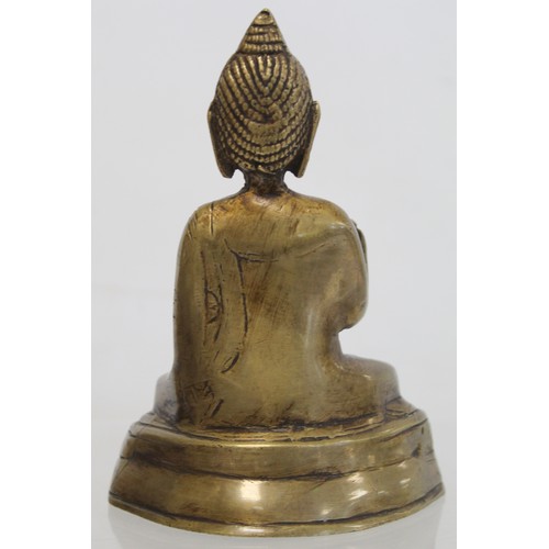 274 - Eastern bronze figure of a Buddha seated on a lotus throne, hollow base, 15cm high.