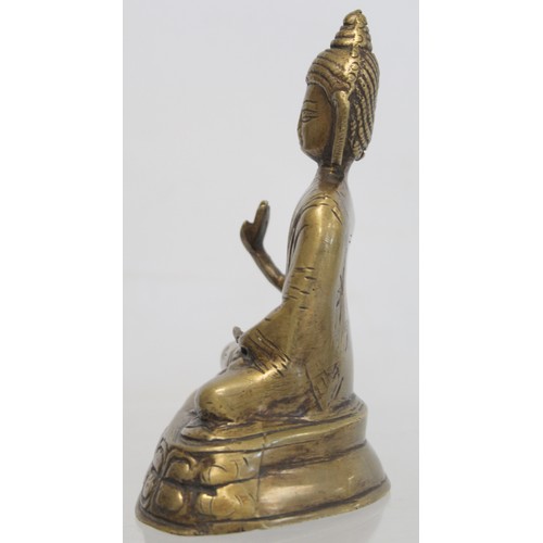 274 - Eastern bronze figure of a Buddha seated on a lotus throne, hollow base, 15cm high.