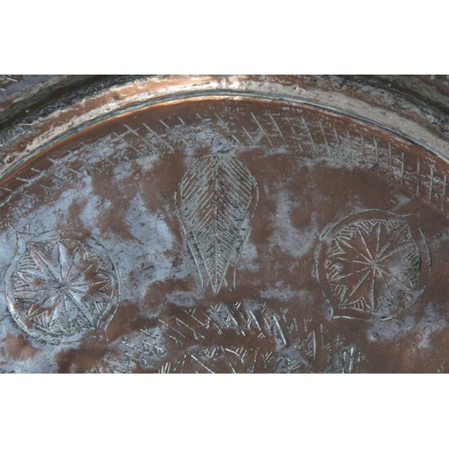 278 - 19th century large Eastern tinned copper circular charger with incised central flowerhead star medal... 