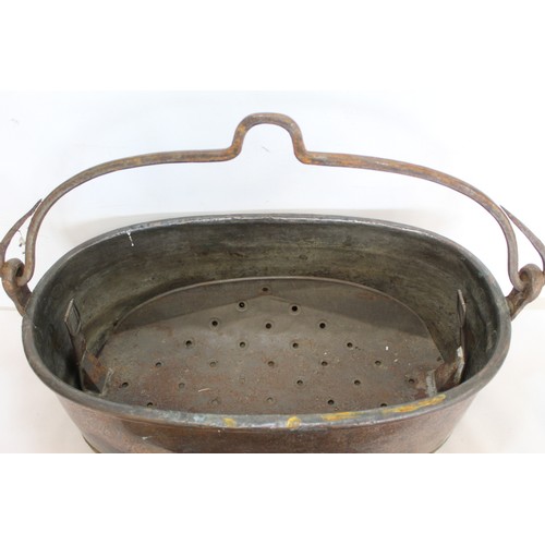 281 - Large 19th century copper fish kettle of oval form with swing handle and lift-out trivet, 61cm long.