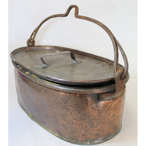 281 - Large 19th century copper fish kettle of oval form with swing handle and lift-out trivet, 61cm long.