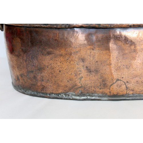 281 - Large 19th century copper fish kettle of oval form with swing handle and lift-out trivet, 61cm long.