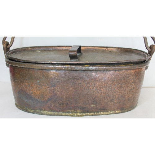 281 - Large 19th century copper fish kettle of oval form with swing handle and lift-out trivet, 61cm long.