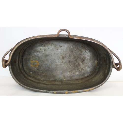 281 - Large 19th century copper fish kettle of oval form with swing handle and lift-out trivet, 61cm long.