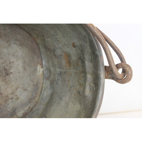 281 - Large 19th century copper fish kettle of oval form with swing handle and lift-out trivet, 61cm long.