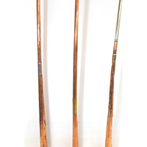 282 - Three copper coach horns, with brass and white metal mounts, 122cm, 101cm and 98cm.  (3).