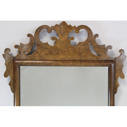 284 - Georgian style walnut veneered wall mirror with fret cut frame, 68cm high.