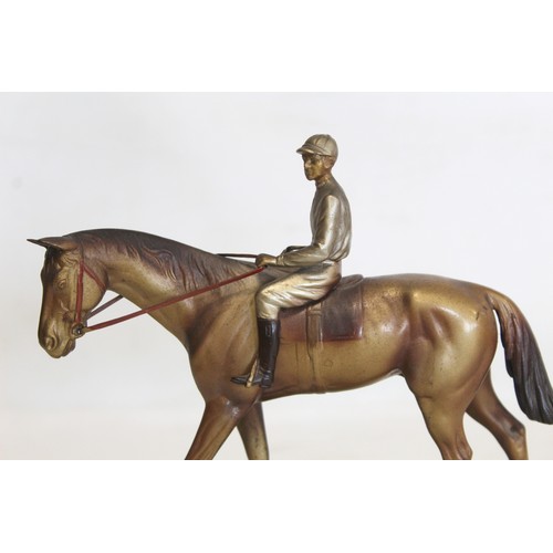 301 - Early 20th century Austrian cold painted bronze figure of a racehorse and jockey on stepped green on... 