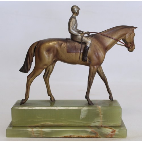 301 - Early 20th century Austrian cold painted bronze figure of a racehorse and jockey on stepped green on... 