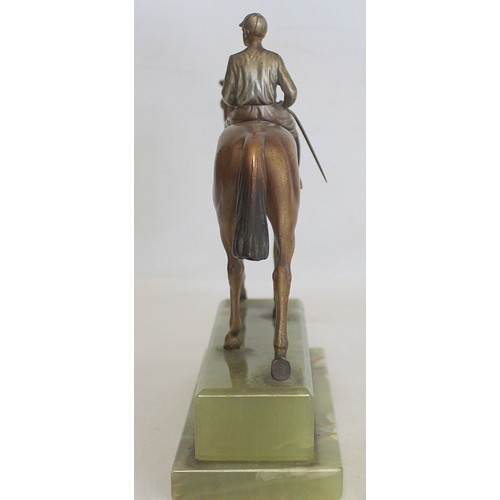 301 - Early 20th century Austrian cold painted bronze figure of a racehorse and jockey on stepped green on... 